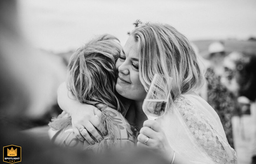 bride hugs her best friend during the wedding day